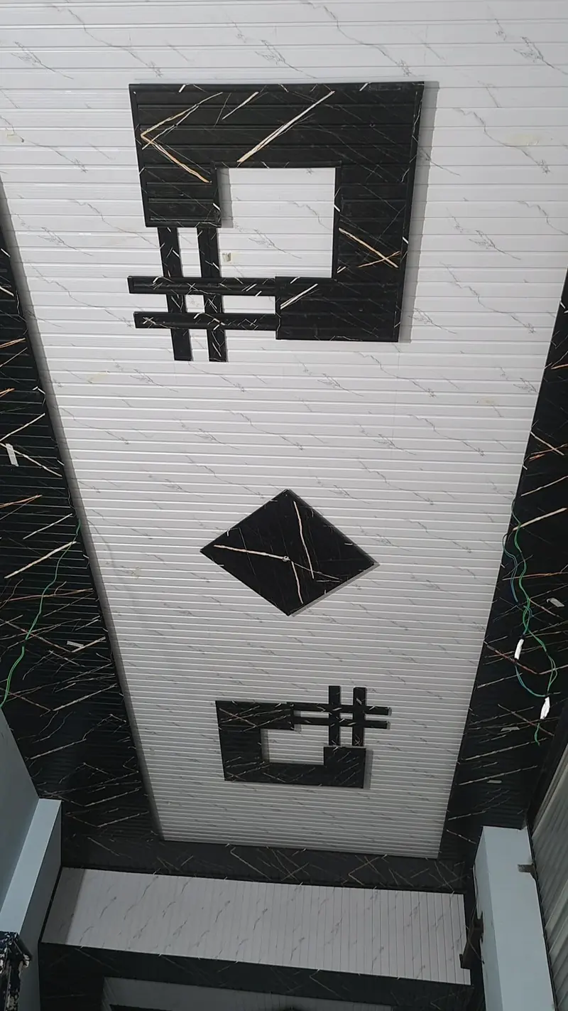 Monochrome marble-print PVC ceiling panels with black geometric inset motifs